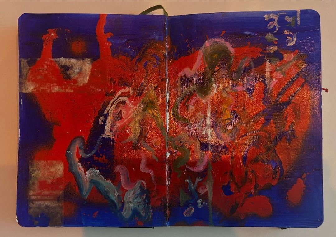 Sketchbook spread in deep ultramarine and hot red with a metallic copper sheen and gestural pink and olive marks.
