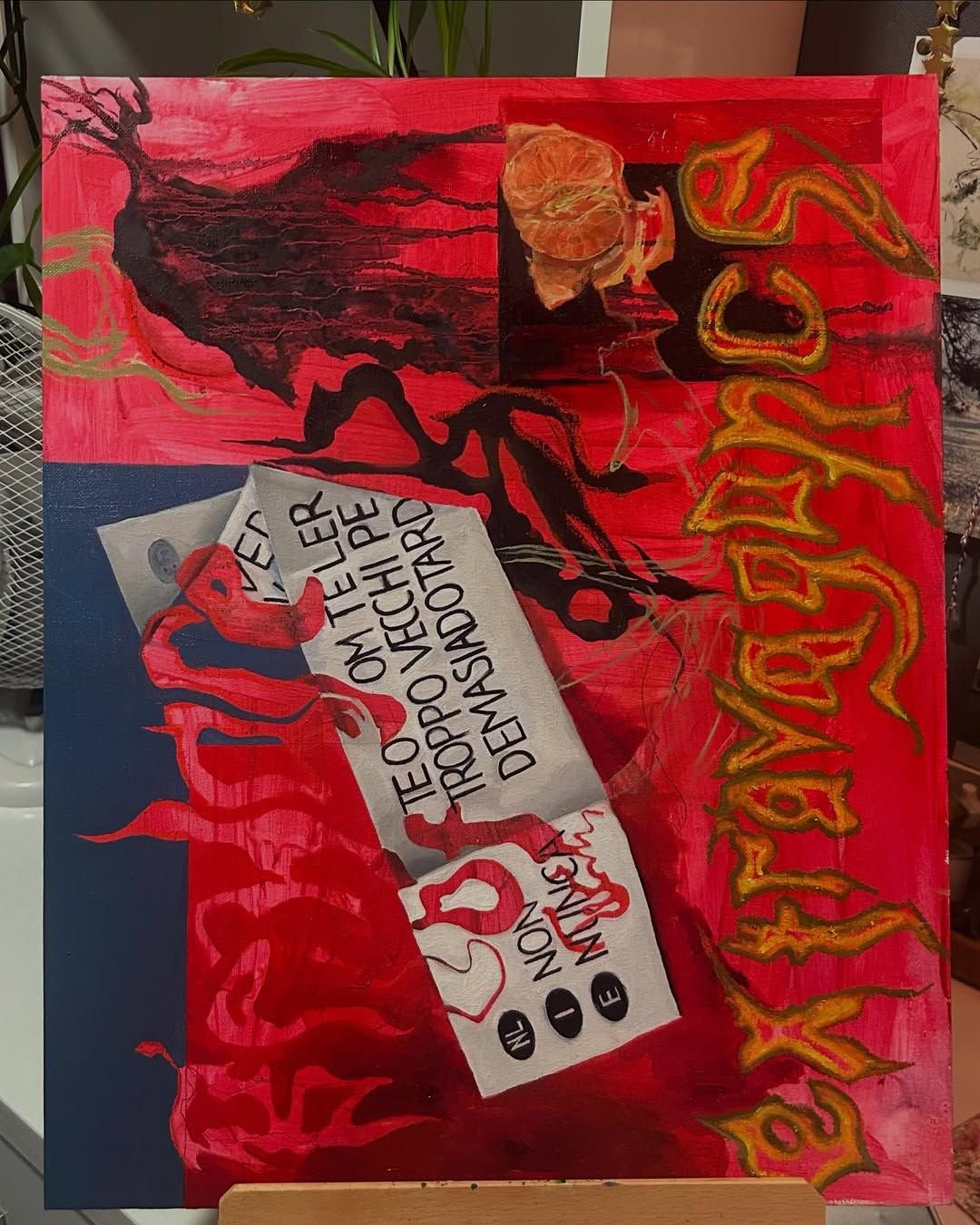 Large mixed-media canvas in vivid red and blue: painted collage strips with multilingual text, a mandarin segment, black gestural forms, and the word 'extravagance' in dripping lettering down the right edge.
