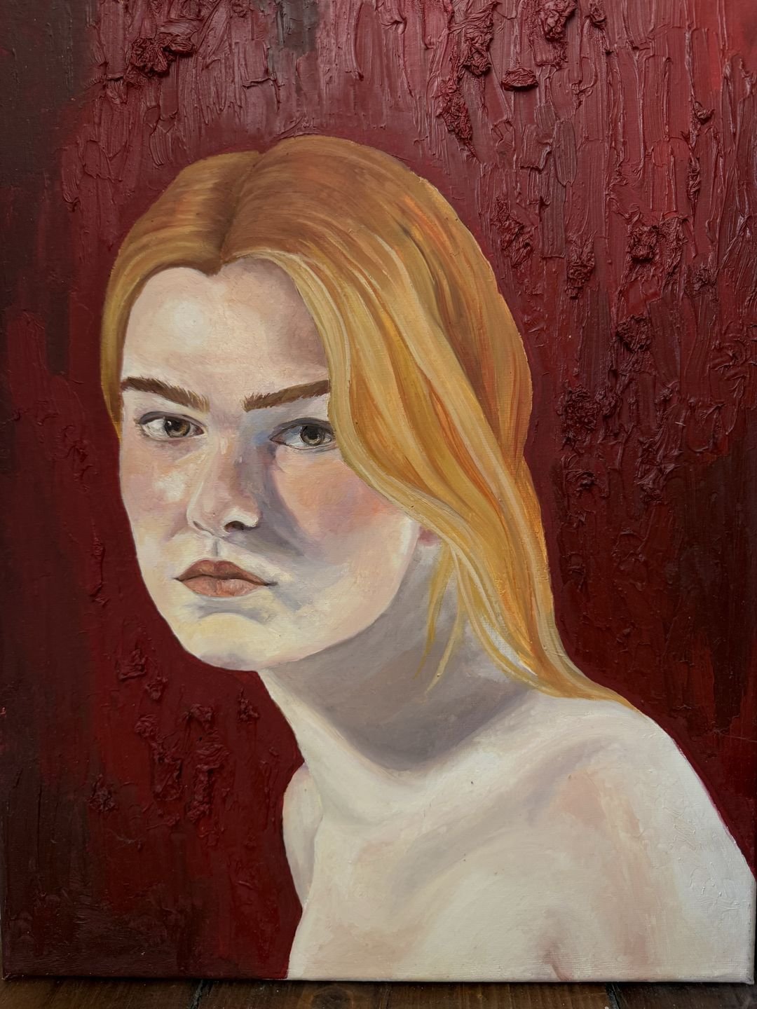 Oil portrait of a fair-haired young woman against a deep red impasto ground; level gaze, cool violet shadows across the skin.